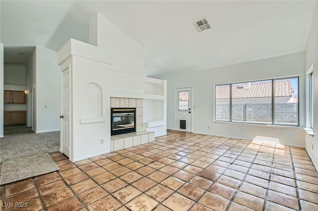 4616 Silversword Ave, North Las Vegas, NV 89032 - unfurnished living room featuring built in features, high vaulted ceiling, and a tile fireplace