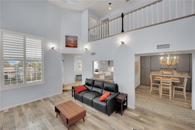 3080 Yankee Clipper Dr, Las Vegas, NV 89117 - living room featuring a high ceiling, light wood-style floors, and a chandelier