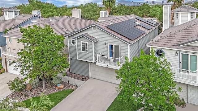 3080 Yankee Clipper Dr, Las Vegas, NV 89117 - view of front facade with a garage, driveway, a balcony, a chimney, and solar panels
