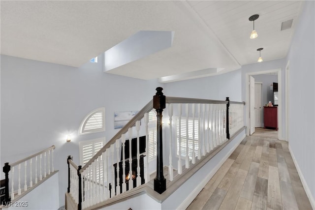 3080 Yankee Clipper Dr, Las Vegas, NV 89117 - hallway featuring wood finished floors and an upstairs landing