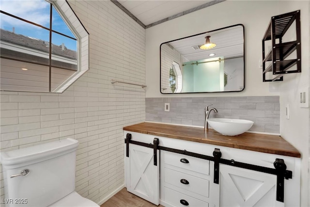 3080 Yankee Clipper Dr, Las Vegas, NV 89117 - bathroom featuring vanity, healthy amount of natural light, tasteful backsplash, and tile walls