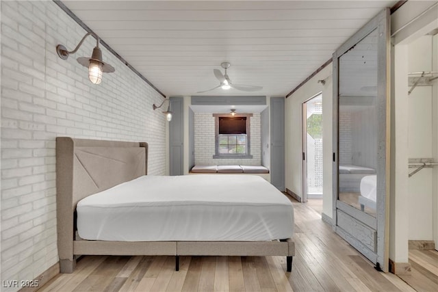 3080 Yankee Clipper Dr, Las Vegas, NV 89117 - bedroom with brick wall, access to exterior, light wood finished floors, and ceiling fan