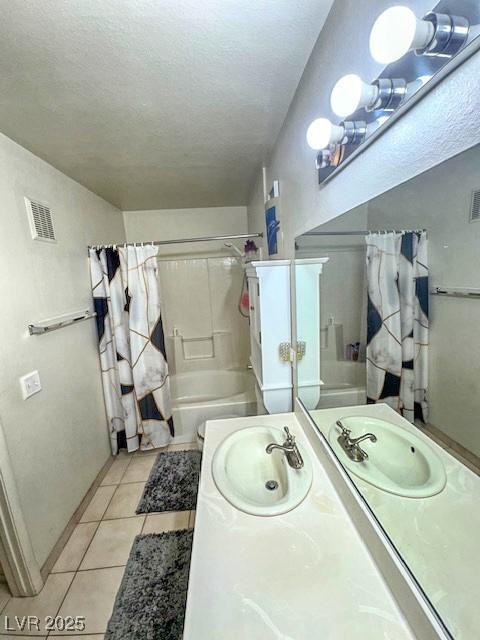 3101 Casey Dr Unit 204, Las Vegas, NV 89120 - bathroom featuring shower / tub combo with curtain, vanity, tile patterned floors, and a textured ceiling