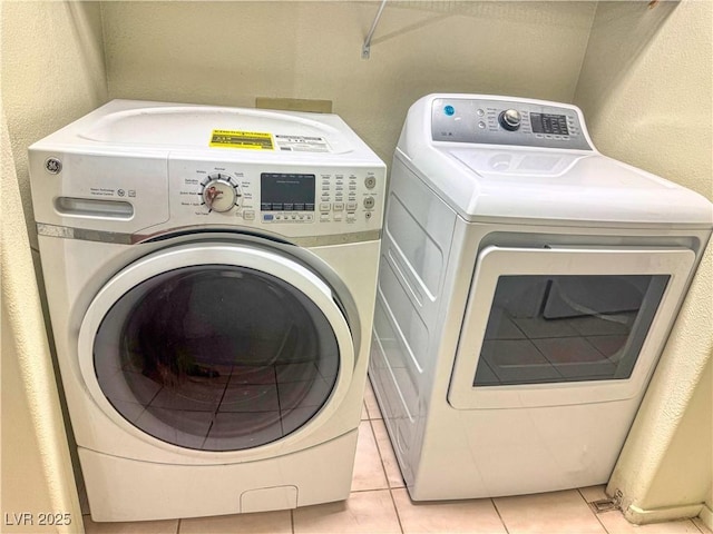 3101 Casey Dr Unit 204, Las Vegas, NV 89120 - washroom with washing machine and clothes dryer, light tile patterned floors, and a textured wall