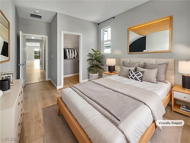 3499 Brezine Ave, Henderson, NV 89044 - bedroom with light wood-style flooring and a spacious closet