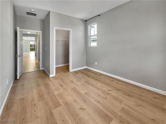 3499 Brezine Ave, Henderson, NV 89044 - unfurnished bedroom featuring light wood-type flooring and a spacious closet