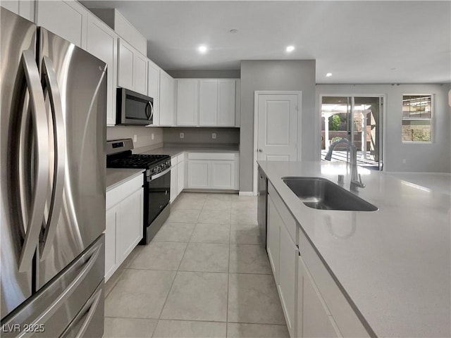 3499 Brezine Ave, Henderson, NV 89044 - kitchen with stainless steel appliances, recessed lighting, white cabinets, light countertops, and light tile patterned floors