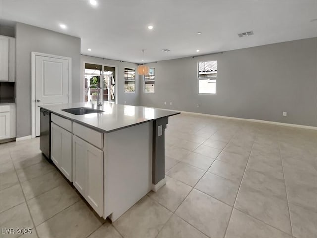 3499 Brezine Ave, Henderson, NV 89044 - kitchen featuring recessed lighting, white cabinets, a center island with sink, dishwashing machine, and light tile patterned floors