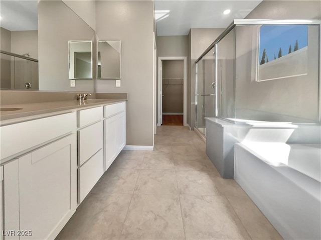 3499 Brezine Ave, Henderson, NV 89044 - full bathroom with a stall shower, double vanity, a bath, a walk in closet, and tile patterned flooring
