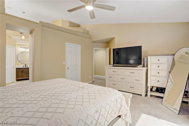 7401 Red Swallow St, Las Vegas, NV 89131 - bedroom with light carpet, connected bathroom, ceiling fan, and vaulted ceiling