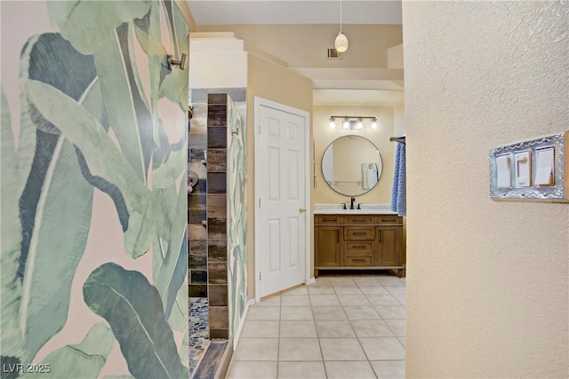 7401 Red Swallow St, Las Vegas, NV 89131 - bathroom featuring vanity, tile patterned floors, walk in shower, and a textured wall