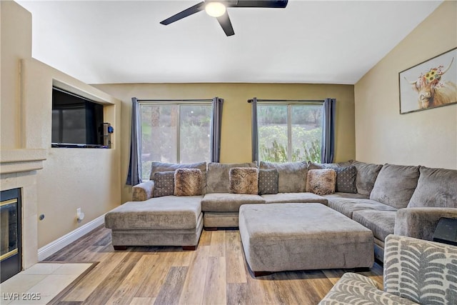 7401 Red Swallow St, Las Vegas, NV 89131 - living room featuring ceiling fan, wood finished floors, and a tile fireplace