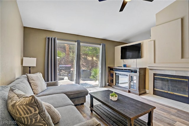 7401 Red Swallow St, Las Vegas, NV 89131 - living room featuring a fireplace, a ceiling fan, and wood finished floors
