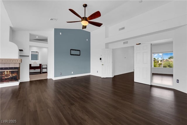 56 Grossinger Ct, Henderson, NV 89074 - unfurnished living room with a ceiling fan, wood finished floors, a tiled fireplace, and high vaulted ceiling