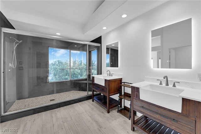 56 Grossinger Ct, Henderson, NV 89074 - full bathroom with recessed lighting, a stall shower, two vanities, and wood finished floors
