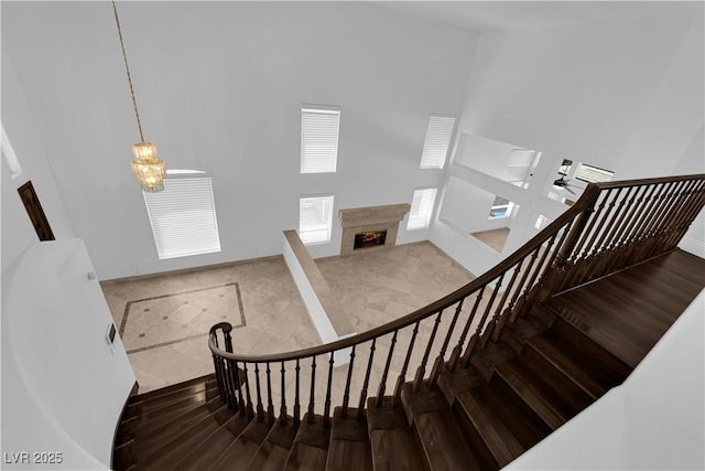 56 Grossinger Ct, Henderson, NV 89074 - stairs with a towering ceiling, a fireplace, and wood finished floors