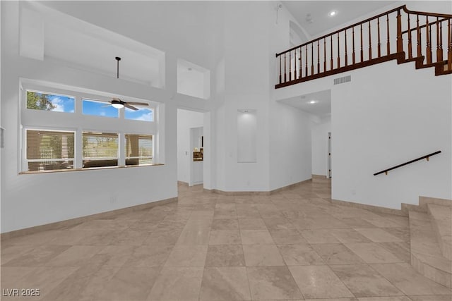 56 Grossinger Ct, Henderson, NV 89074 - unfurnished living room with a ceiling fan, stairs, a high ceiling, tile patterned floors, and recessed lighting