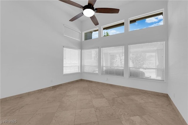 56 Grossinger Ct, Henderson, NV 89074 - spare room featuring a high ceiling, ceiling fan, and healthy amount of natural light