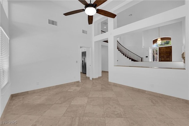56 Grossinger Ct, Henderson, NV 89074 - unfurnished living room with ceiling fan, a high ceiling, and stairs
