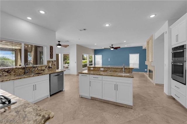 56 Grossinger Ct, Henderson, NV 89074 - kitchen featuring stainless steel appliances, a ceiling fan, recessed lighting, dark stone counters, and open floor plan