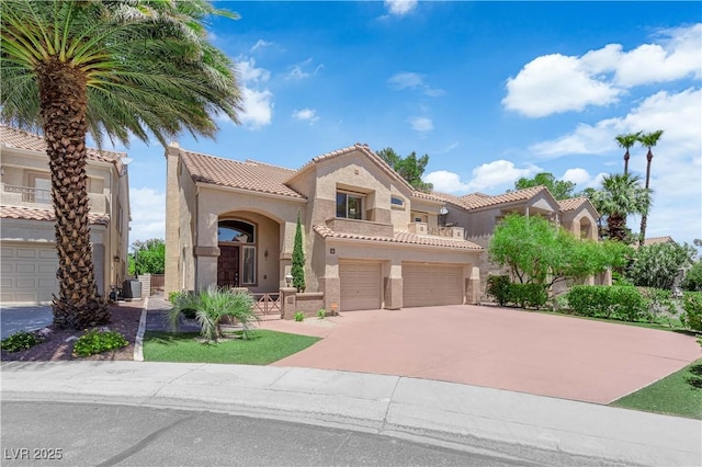 56 Grossinger Ct, Henderson, NV 89074 - mediterranean / spanish-style home featuring stucco siding, a tiled roof, driveway, a garage, and a balcony