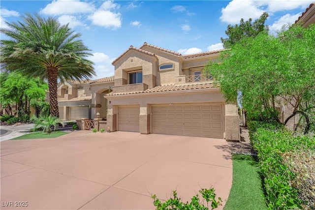 56 Grossinger Ct, Henderson, NV 89074 - mediterranean / spanish-style home with a tile roof, stucco siding, an attached garage, concrete driveway, and a balcony