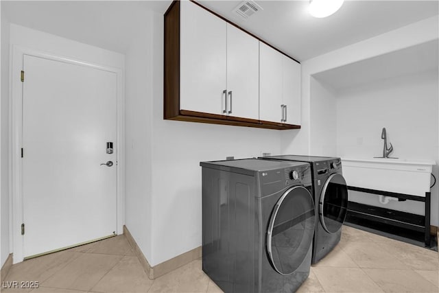 56 Grossinger Ct, Henderson, NV 89074 - laundry area with cabinet space, separate washer and dryer, and light tile patterned floors