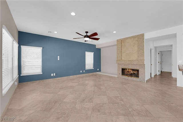 56 Grossinger Ct, Henderson, NV 89074 - unfurnished living room featuring ceiling fan, recessed lighting, a fireplace, and light tile patterned floors