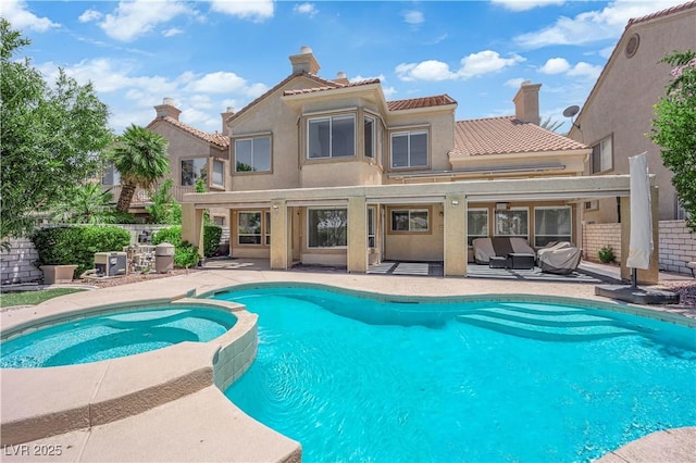 56 Grossinger Ct, Henderson, NV 89074 - back of property featuring a patio area, a pool with connected hot tub, stucco siding, a tiled roof, and outdoor lounge area