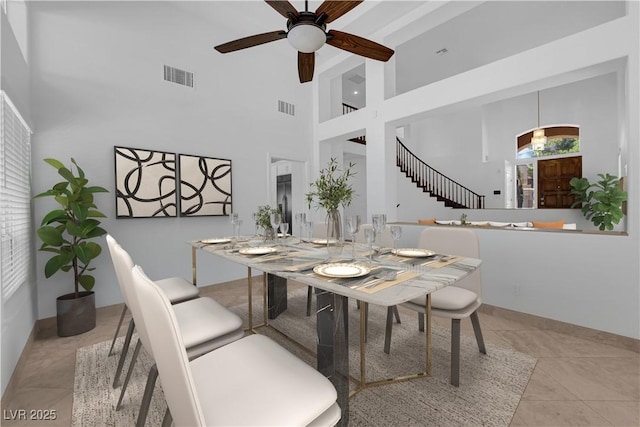 56 Grossinger Ct, Henderson, NV 89074 - tiled dining space featuring ceiling fan, a towering ceiling, and stairs