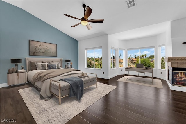 56 Grossinger Ct, Henderson, NV 89074 - bedroom with lofted ceiling, a tiled fireplace, wood finished floors, and ceiling fan