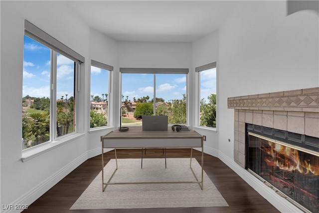 56 Grossinger Ct, Henderson, NV 89074 - office area featuring plenty of natural light, a tile fireplace, and dark wood finished floors