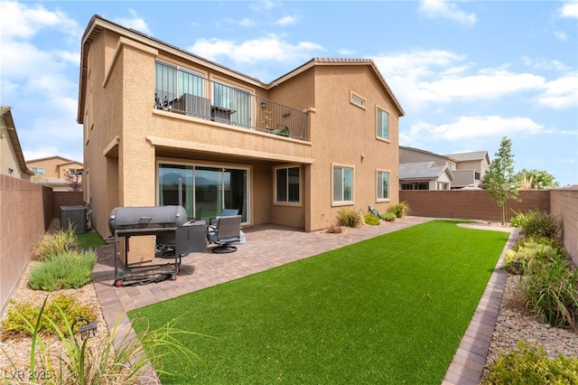 7107 Calvert Cliffs St, North Las Vegas, NV 89084 - rear view of house featuring a balcony, stucco siding, a fenced backyard, and a patio