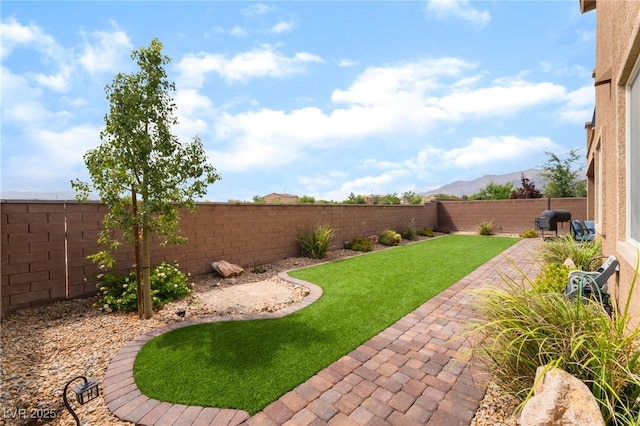 7107 Calvert Cliffs St, North Las Vegas, NV 89084 - fenced backyard featuring a mountain view and a patio