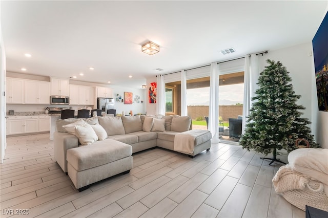 7107 Calvert Cliffs St, North Las Vegas, NV 89084 - living room with recessed lighting, light wood-style flooring, and expansive windows
