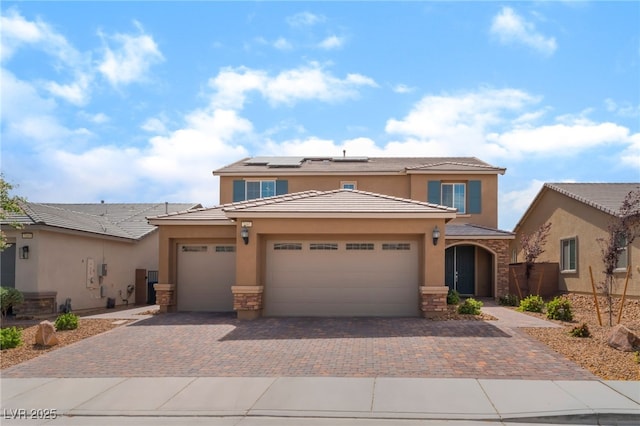 7107 Calvert Cliffs St, North Las Vegas, NV 89084 - view of front of property featuring stucco siding, stone siding, roof mounted solar panels, and driveway