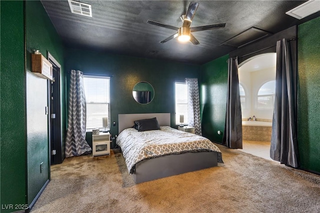 8169 Skytop Ledge Ave, Las Vegas, NV 89178 - bedroom with multiple windows, carpet flooring, a ceiling fan, and ensuite bathroom