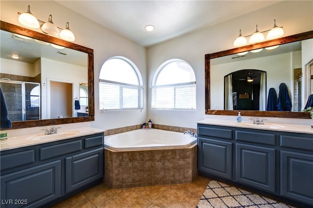 8169 Skytop Ledge Ave, Las Vegas, NV 89178 - bathroom featuring two vanities, tile patterned floors, a bath, and a shower stall