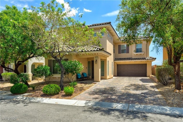 8169 Skytop Ledge Ave, Las Vegas, NV 89178 - mediterranean / spanish home featuring a tiled roof, a garage, decorative driveway, stucco siding, and covered porch