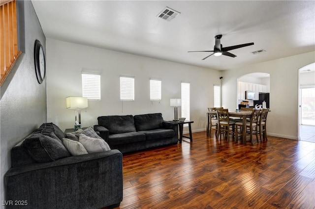 8169 Skytop Ledge Ave, Las Vegas, NV 89178 - living area with arched walkways, wood finished floors, and a ceiling fan