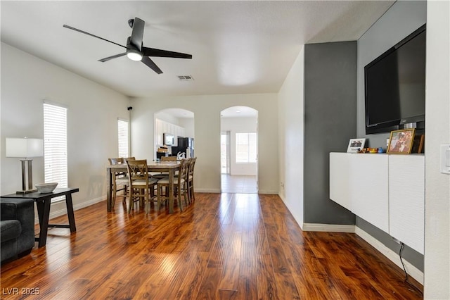 8169 Skytop Ledge Ave, Las Vegas, NV 89178 - dining room featuring arched walkways, dark wood-style flooring, and ceiling fan