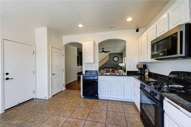 8169 Skytop Ledge Ave, Las Vegas, NV 89178 - kitchen featuring black appliances, arched walkways, light tile patterned flooring, white cabinetry, and recessed lighting