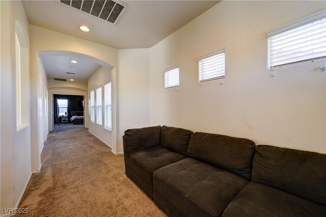 8169 Skytop Ledge Ave, Las Vegas, NV 89178 - living room with light colored carpet, arched walkways, and recessed lighting