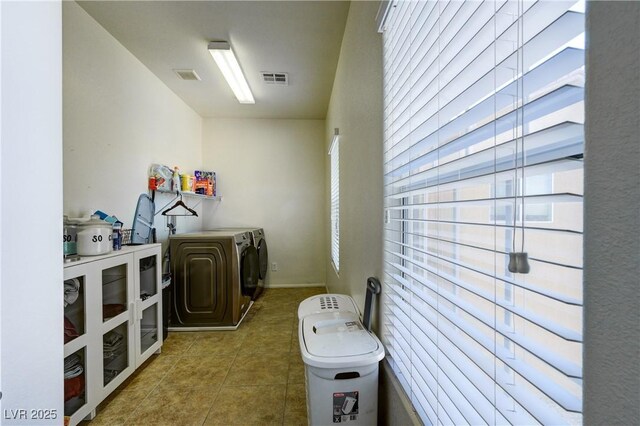 8169 Skytop Ledge Ave, Las Vegas, NV 89178 - washroom with washer and clothes dryer, plenty of natural light, and tile patterned flooring