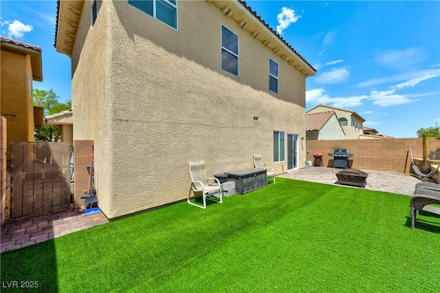 8169 Skytop Ledge Ave, Las Vegas, NV 89178 - back of house featuring stucco siding and a patio area