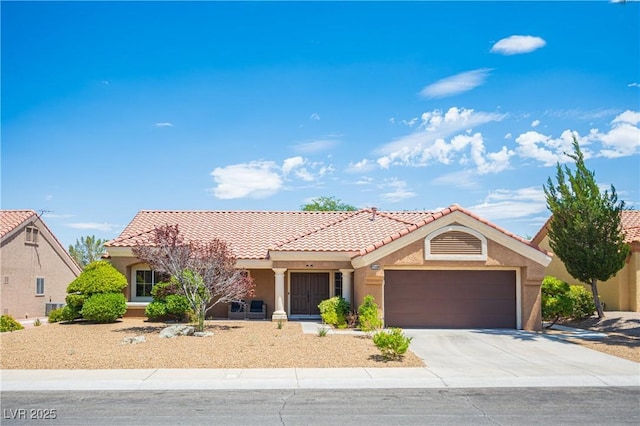 2548 Tumble Brook Dr, Las Vegas, NV 89134 - mediterranean / spanish-style house with concrete driveway, an attached garage, stucco siding, and a tile roof