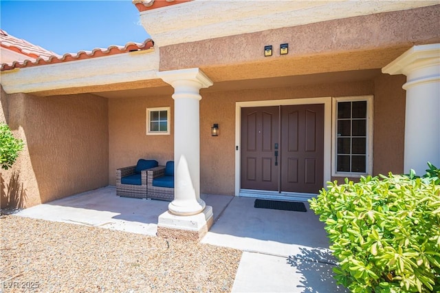 2548 Tumble Brook Dr, Las Vegas, NV 89134 - view of exterior entry with stucco siding and a porch