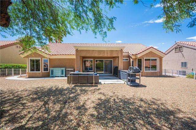 2548 Tumble Brook Dr, Las Vegas, NV 89134 - rear view of property featuring a tiled roof, a fenced backyard, stucco siding, and an outdoor hangout area