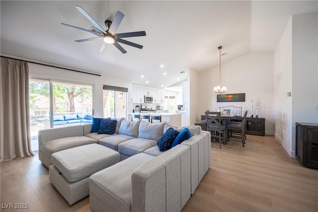 2548 Tumble Brook Dr, Las Vegas, NV 89134 - living room featuring lofted ceiling, a chandelier, a ceiling fan, light wood finished floors, and recessed lighting