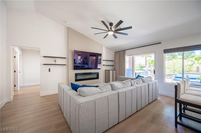 2548 Tumble Brook Dr, Las Vegas, NV 89134 - living area with a ceiling fan, light wood finished floors, healthy amount of natural light, and high vaulted ceiling